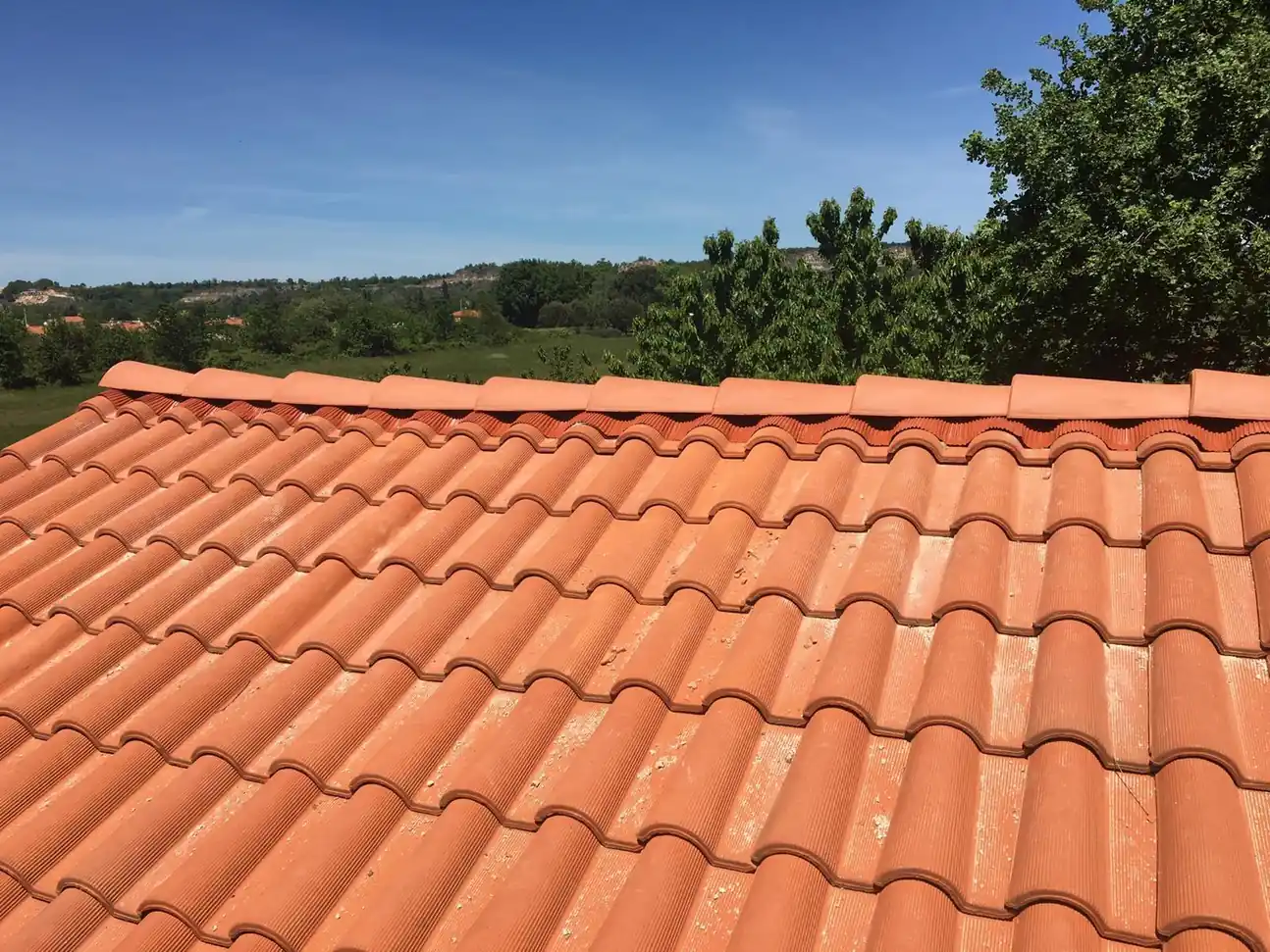 Couverture en tuile neuve sous un ciel bleu, rangs réguliers