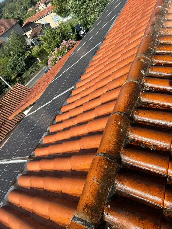 Tuiles neuves posées à côté de panneaux en toiture
